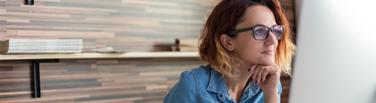 Woman wearing eyeglasses at her desk