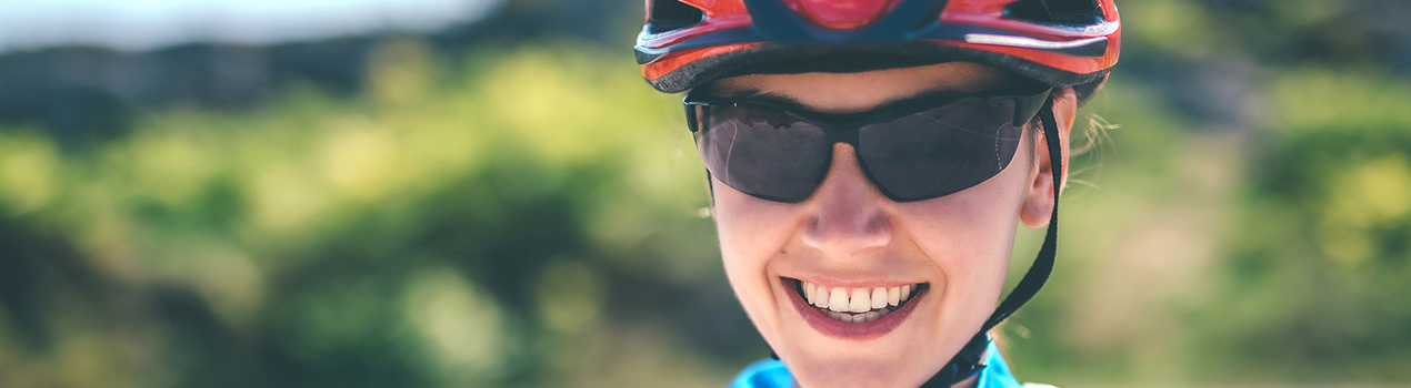 Woman wearing protective eyeglasses while biking